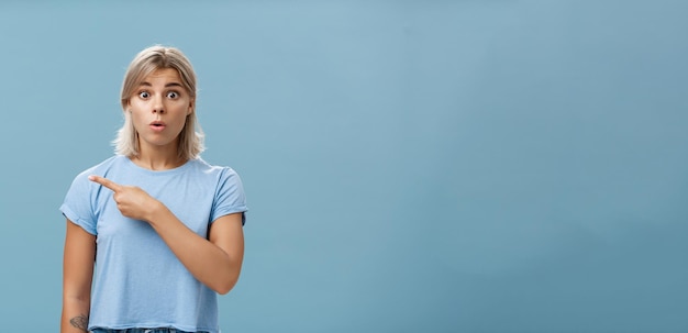 Free photo studio shot of amazed stunned cute blonde witnessing unbelievable event gasping opening mouth