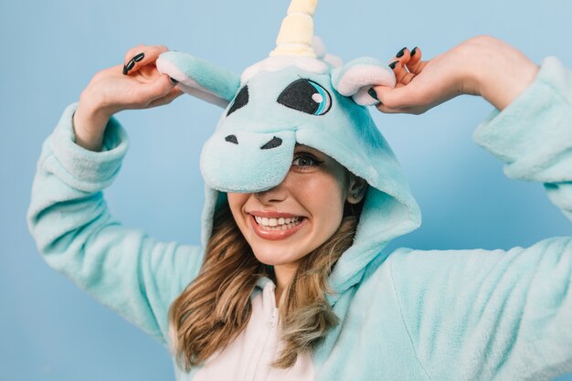 Studio shot of inspired woman wears unicorn kigurumi