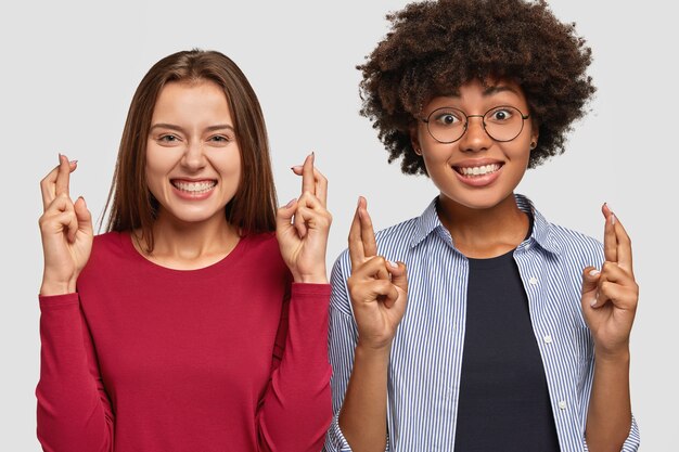 Studio shot of positive students pose pass exam successfully after second try