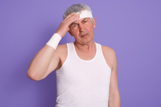 Studio shot of senior male with headache