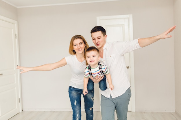 Studio shot of two parents playing with their boy child.