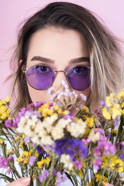 Studio shot of woman with flowers