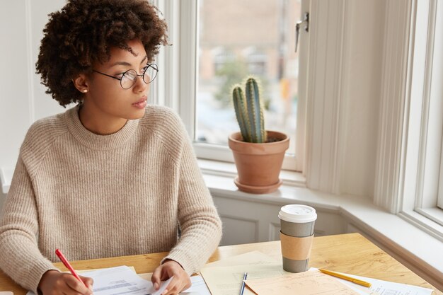 Study education, work concept. Thoughtful female banker fills in documentation, holds pen