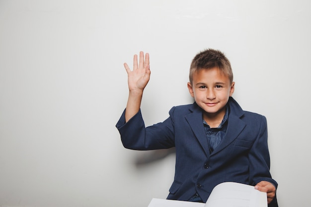 Studying kid with hand up