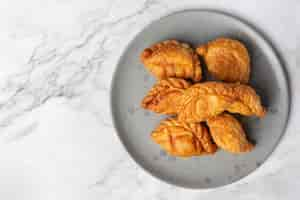 Free photo stuffed chicken curry puffs on the table.