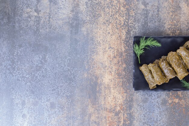 Stuffed grape leaves dolma on plate.