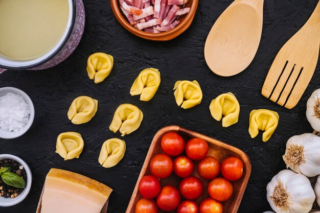 Stuffed pasta amidst ingredients and kitchenware