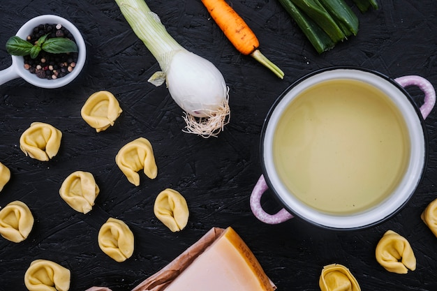 Stuffed pasta and ingredients near saucepan