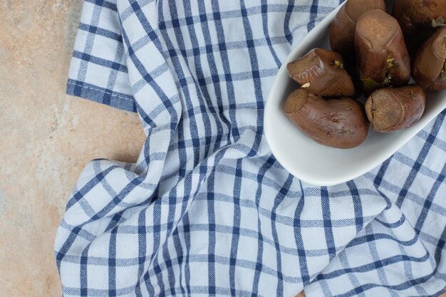 Stuffed pickled eggplants in white bowl