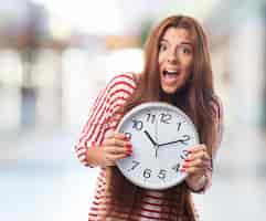 Free photo stunning brunette with clock in hands.