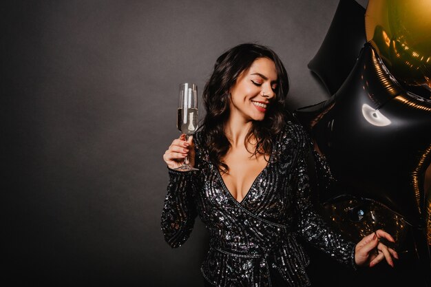 Stunning curly woman enjoying champagne