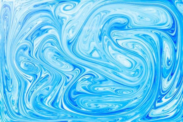 Free photo the style of ebru painting with blue acrylic paint swirls