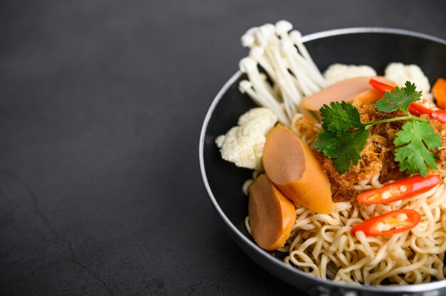 The style still life with noodles in the pan.