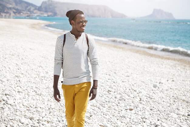 Stylish African-American man on beach