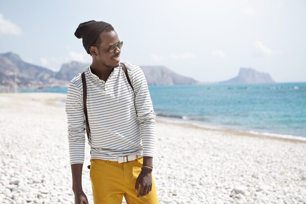 Stylish African-American man on beach