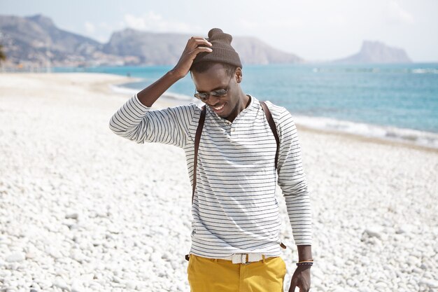 Stylish African-American man on beach