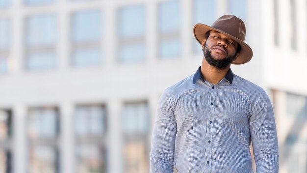 Stylish african american man posing outdoors with copy space