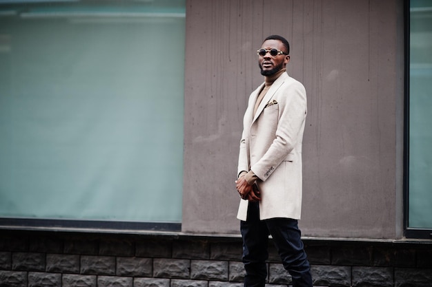 Stylish african american man wear beige jacket with sunglasses