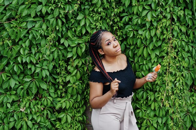 Stylish african american woman at sunglasses with ice cream