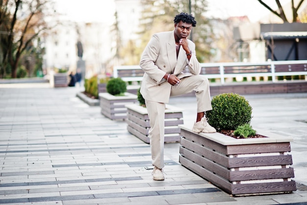 Stylish afro man in beige old school suit Fashionable young African male in casual jacket on bare torso