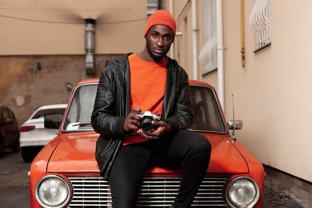 Stylish afroamerican man holding camera