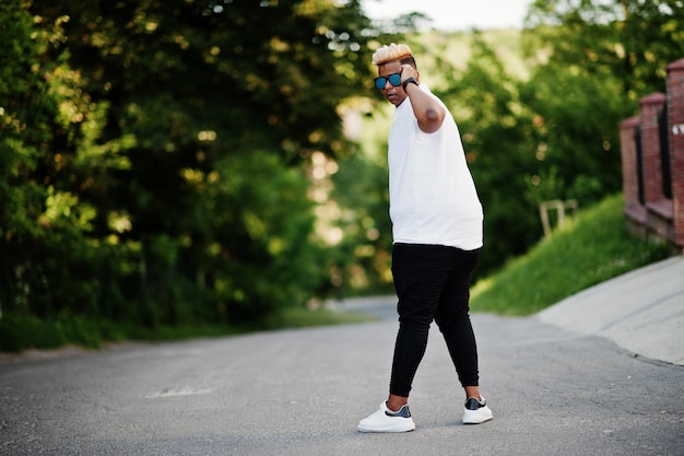 Stylish arabian muslim boy with originally hair and sunglasses posed on streets