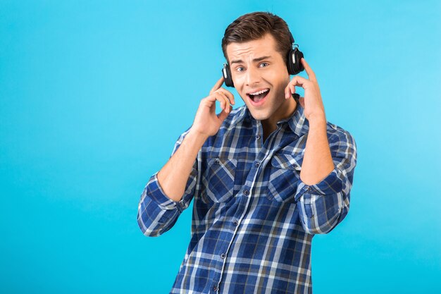 stylish attractive handsome young man listening to music on wireless headphones 