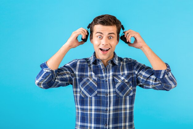 stylish attractive handsome young man listening to music on wireless headphones 