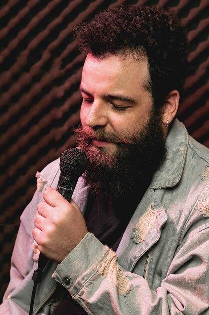 Stylish beard man singing on microphone