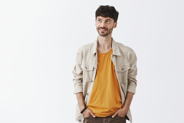 Free photo stylish bearded guy posing against the white wall