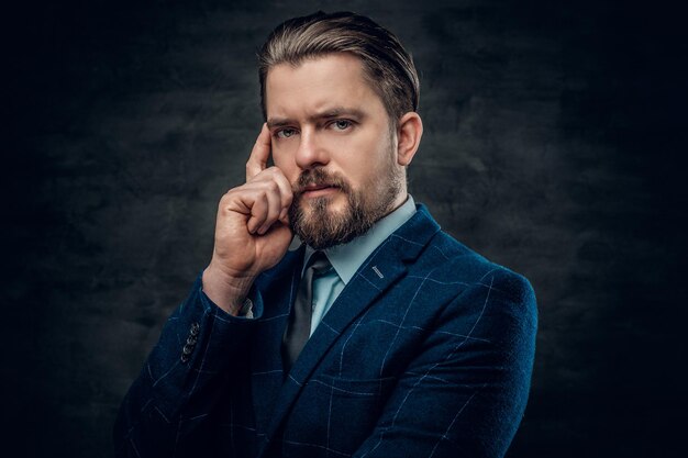 Stylish bearded male wearing a suit and bow tie.