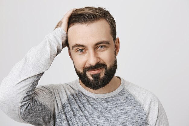 Stylish bearded man likes new haircut