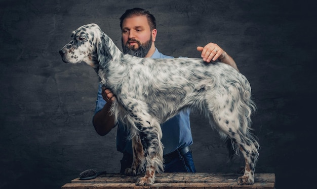 Stylish bearded middle age male and Irish setter.