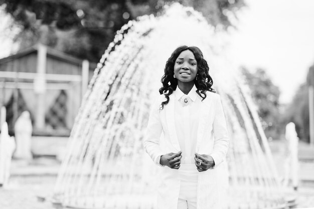 Stylish and beautiful black african american girl background fountain at city