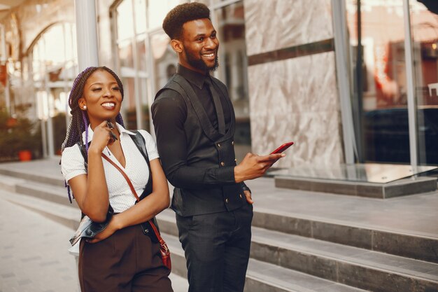 A stylish and beautiful dark-skinned couple in a city