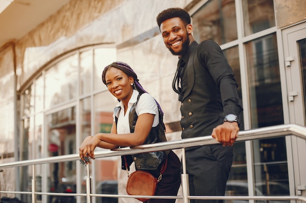 A stylish and beautiful dark-skinned couple in a city