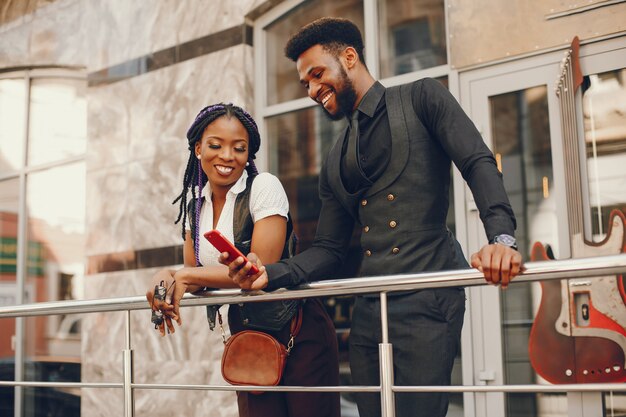 A stylish and beautiful dark-skinned couple in a city