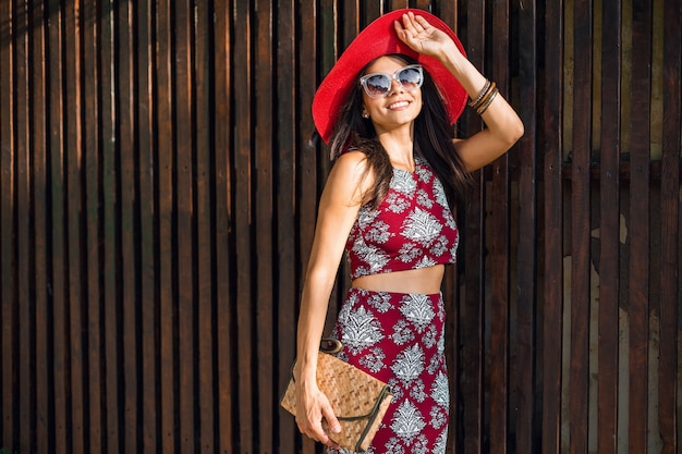 Stylish beautiful woman posing on wooden