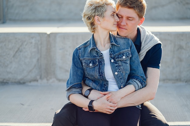 stylish and beautiful woman with short light hair, dressed in a blue jeans jacket