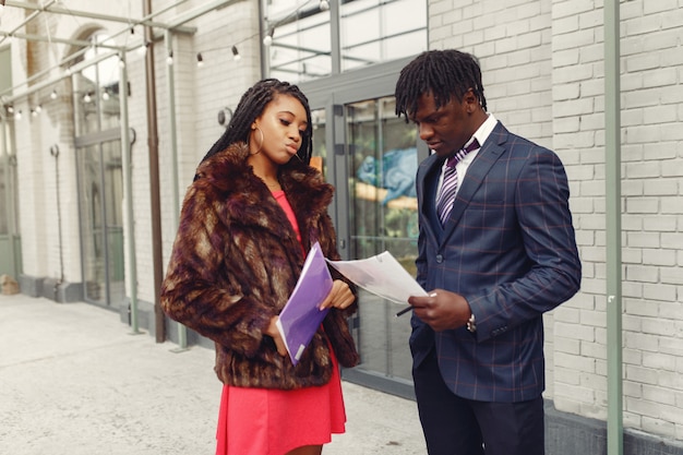 Free photo stylish black couple having a business conversation