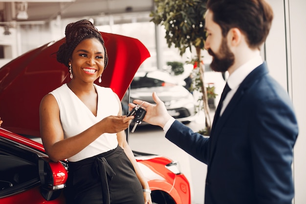 Free photo stylish black woman in a car salon