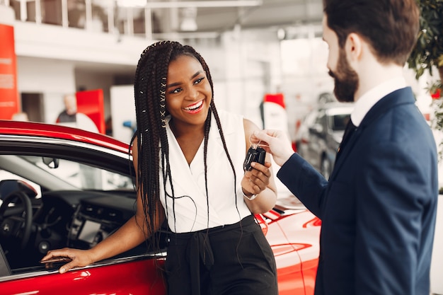 Stylish black woman in a car salon