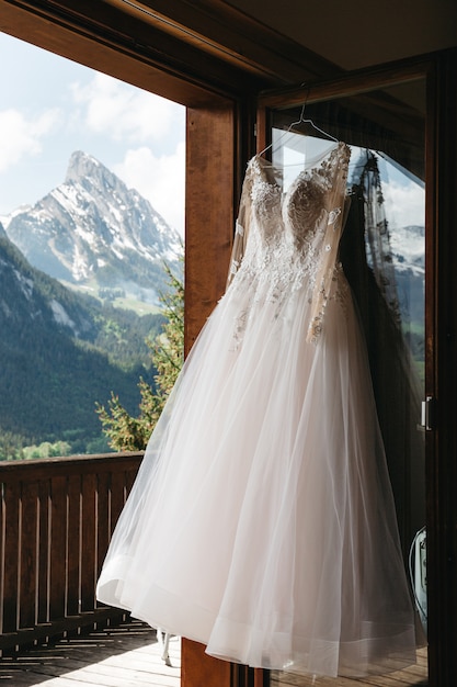 Stylish bride dress on sunny mountains