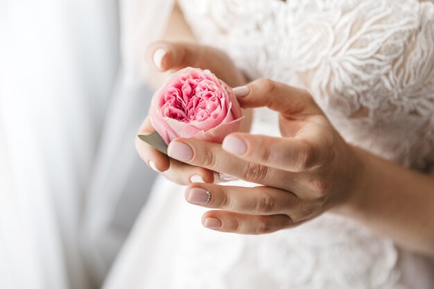 Stylish bride holds a rose