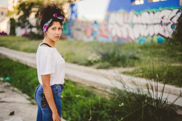 Stylish brunette woman standing outside