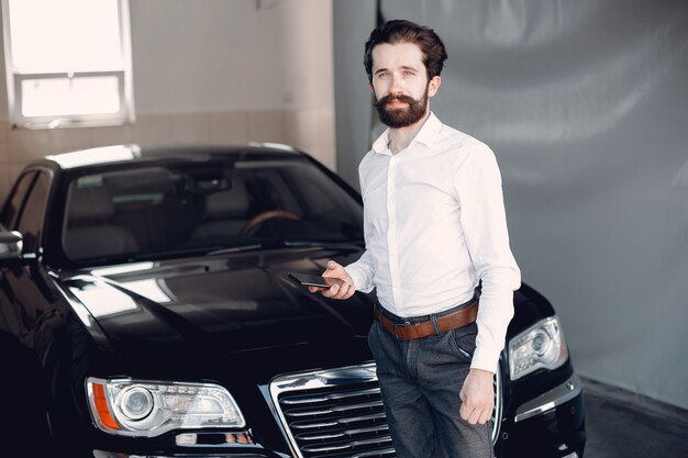 Stylish businessman working near the car