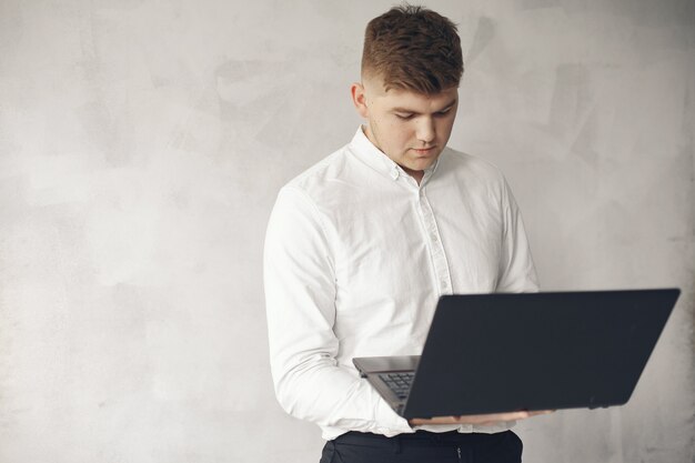 Stylish businessman working in a office and use the laptop