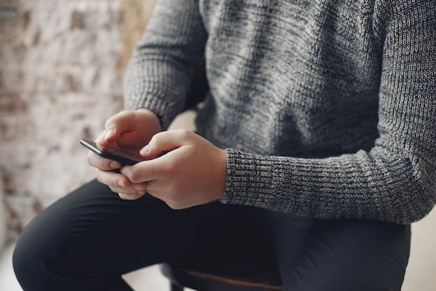 Stylish businessman working in a office and use the phone