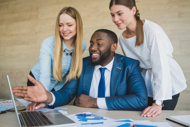 Stylish businesspersons looking at laptop