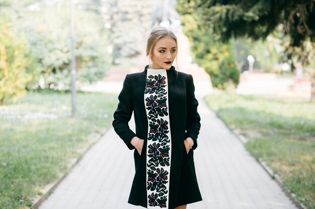 stylish businesswoman walking an posing